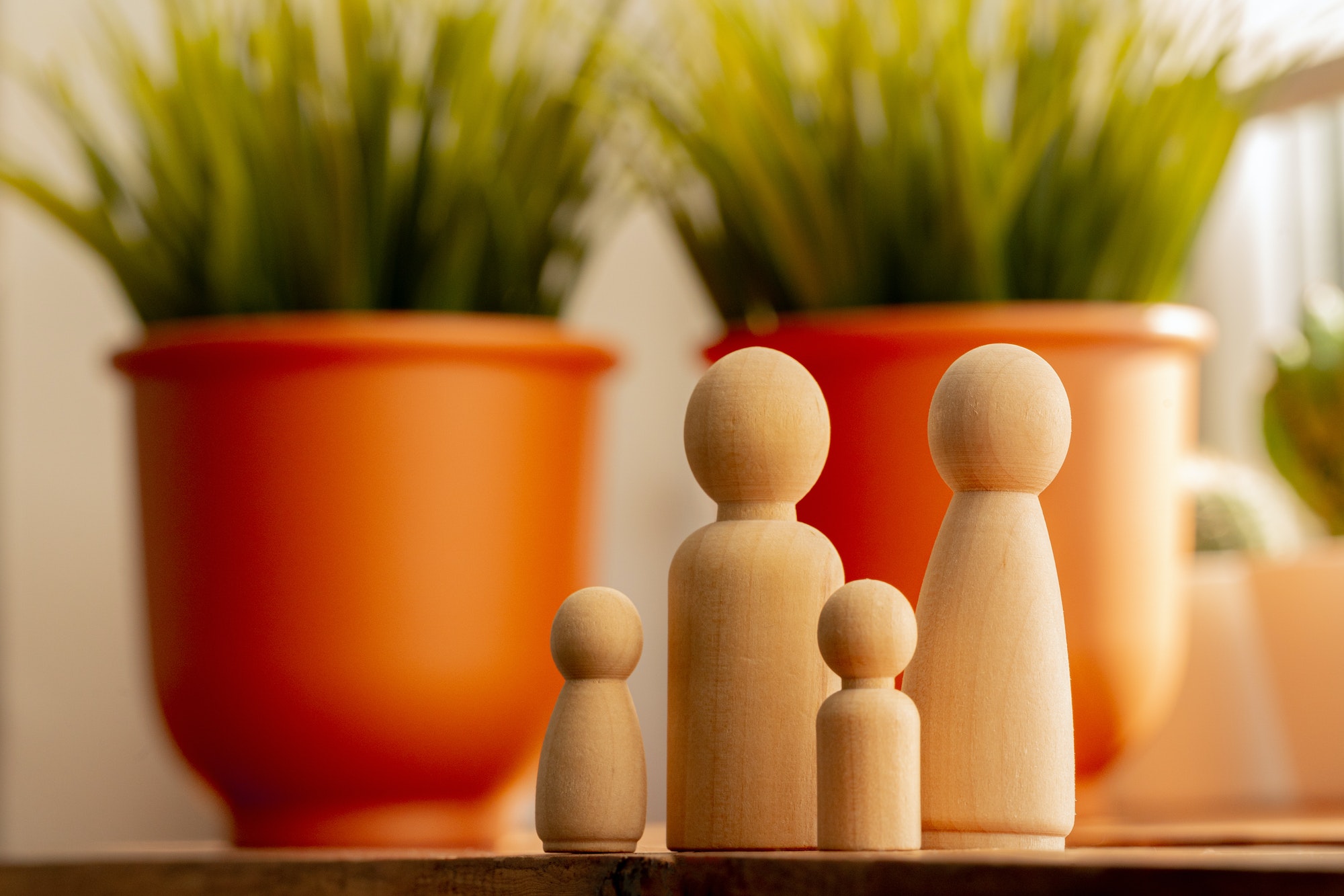 Small wooden figures of family members. Family relationship symbol
